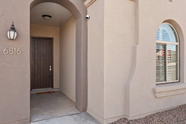 property entrance with stucco siding