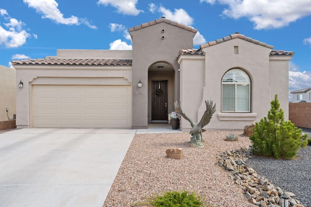 6816 Cleary Loop NE, Rio Rancho, NM 87144 - mediterranean / spanish-style house featuring a tile roof, driveway, an attached garage, and stucco siding