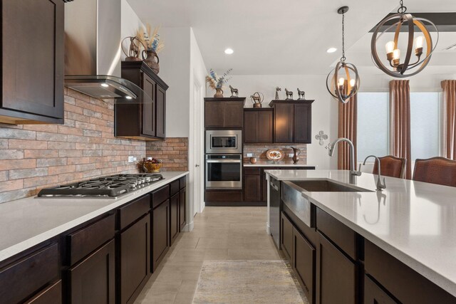 kitchen featuring a sink, dark brown cabinets, ventilation hood, light countertops, and appliances with stainless steel finishes