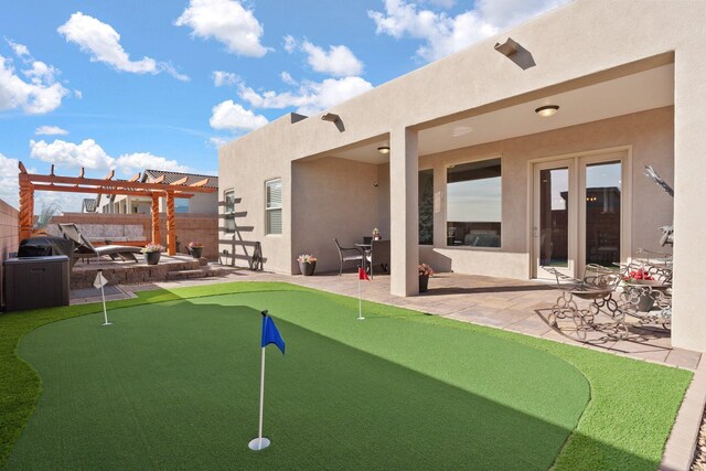 exterior space with a pergola, a patio area, fence, and stucco siding