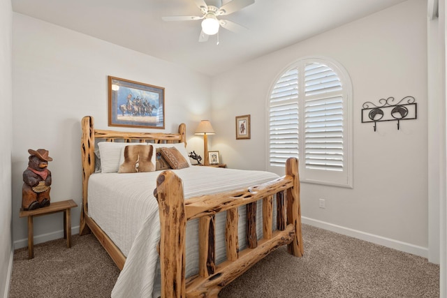 carpeted bedroom with ceiling fan and baseboards