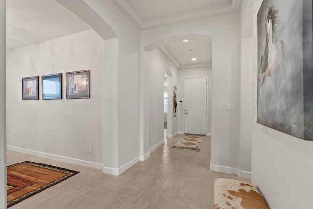 interior space with baseboards, arched walkways, and recessed lighting