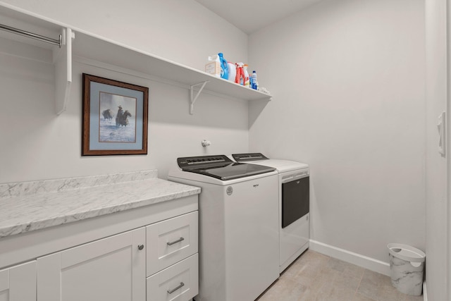 clothes washing area featuring laundry area, baseboards, and independent washer and dryer