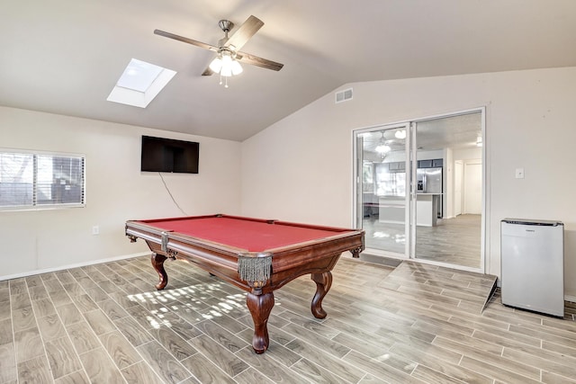 game room featuring lofted ceiling, wood tiled floor, visible vents, and a ceiling fan