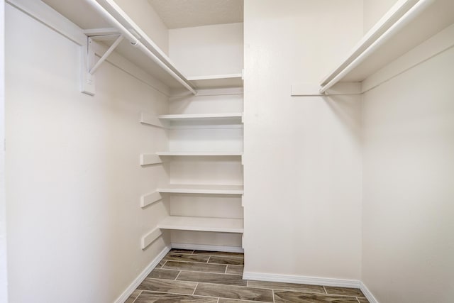 spacious closet featuring wood tiled floor