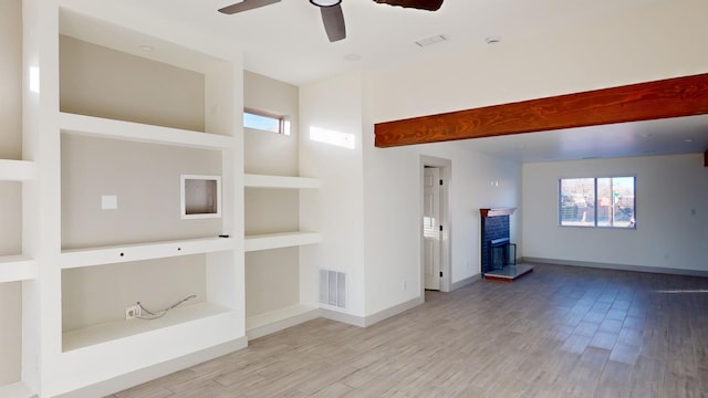 unfurnished living room featuring light wood-type flooring and ceiling fan