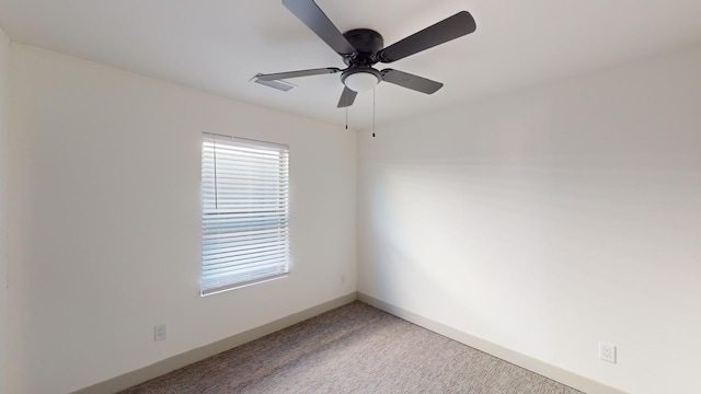 carpeted empty room featuring ceiling fan