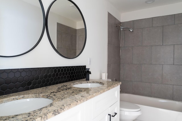 full bathroom featuring vanity, tasteful backsplash, toilet, and tiled shower / bath