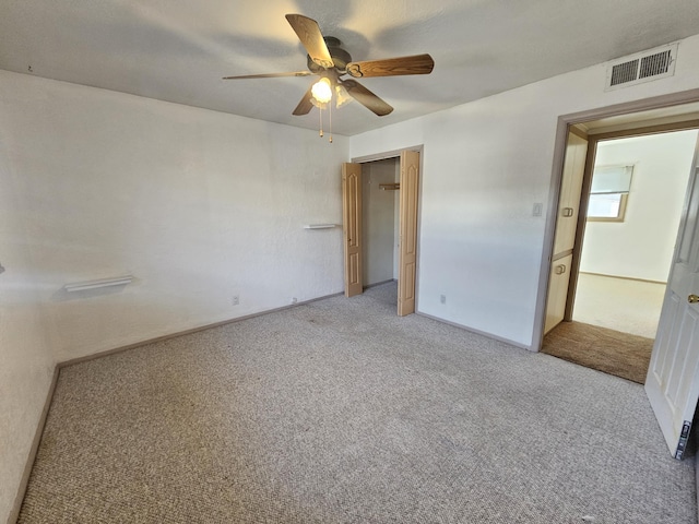 unfurnished bedroom featuring light colored carpet, a closet, and ceiling fan