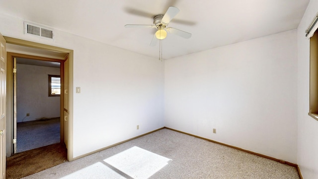 unfurnished room featuring ceiling fan and carpet