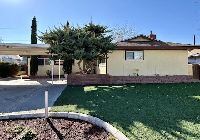 view of property exterior featuring a yard and a patio area