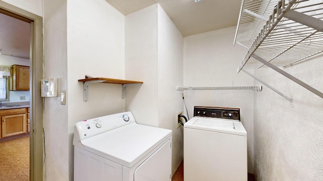 laundry area featuring independent washer and dryer and sink