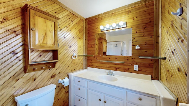 bathroom featuring vanity, a shower with door, and toilet