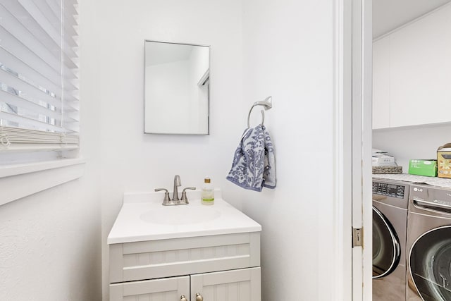 bathroom featuring vanity and independent washer and dryer