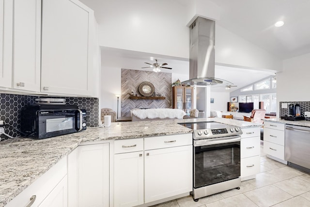 kitchen with vaulted ceiling, appliances with stainless steel finishes, island exhaust hood, and white cabinetry