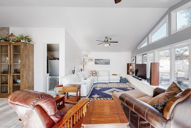 living room featuring ceiling fan, light wood-type flooring, and lofted ceiling