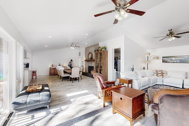 living room featuring light wood-type flooring and a high end fireplace