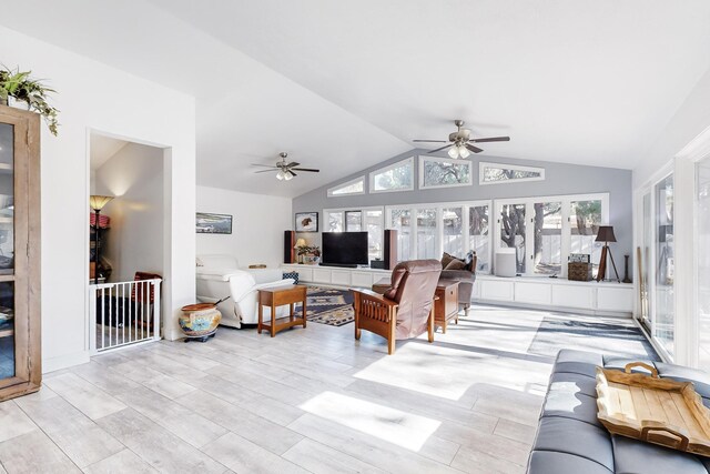 living room featuring ceiling fan, lofted ceiling, and light hardwood / wood-style flooring