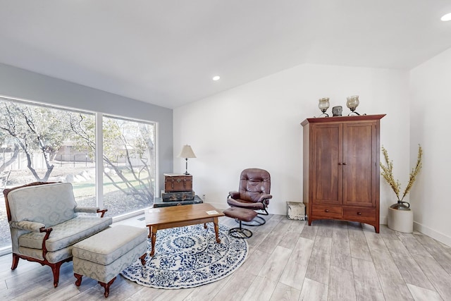 sitting room with vaulted ceiling and light hardwood / wood-style floors