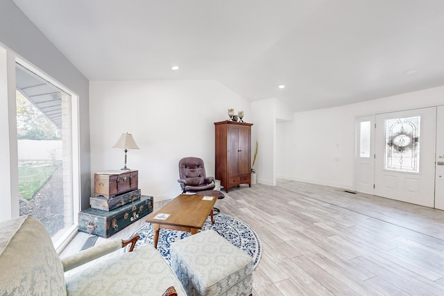 living room with lofted ceiling and light wood-type flooring