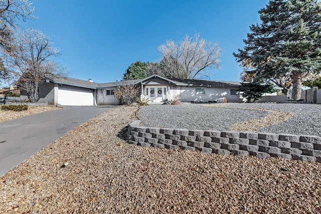 ranch-style home featuring a garage