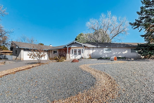 ranch-style home featuring a garage