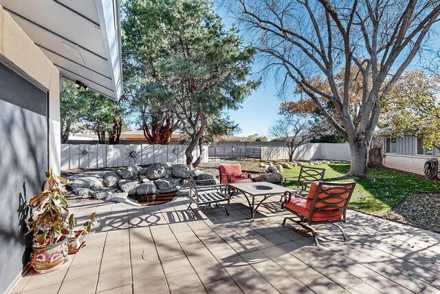 view of patio featuring a wooden deck and an outdoor fire pit