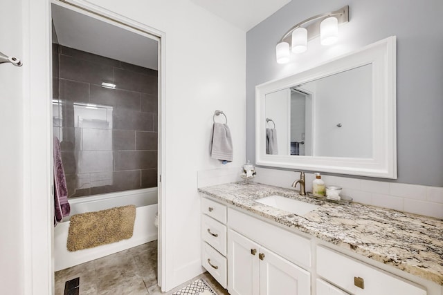 bathroom featuring a tile shower and vanity