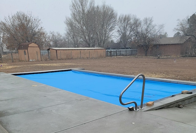 view of swimming pool with a storage unit