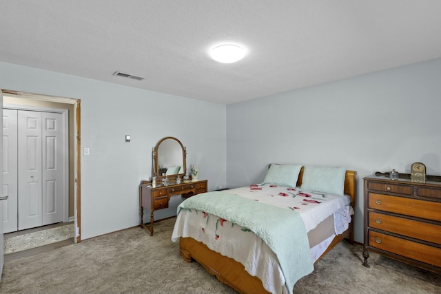 carpeted bedroom with a textured ceiling