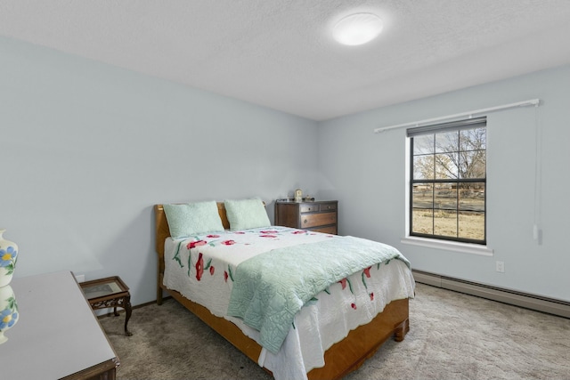 bedroom with carpet floors and a baseboard heating unit