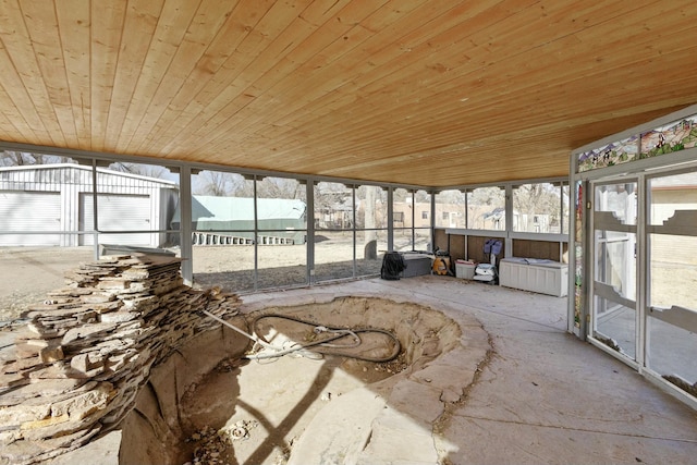 unfurnished sunroom featuring wood ceiling