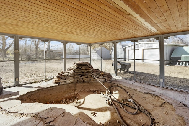 unfurnished sunroom with wood ceiling