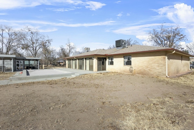 back of house with central AC unit