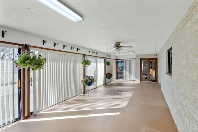 interior space with ceiling fan