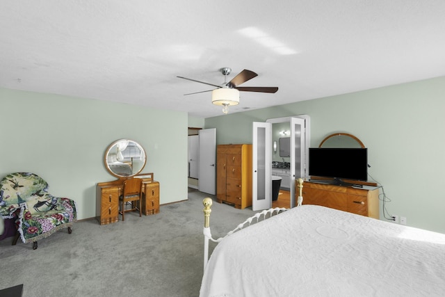 carpeted bedroom featuring ceiling fan and connected bathroom