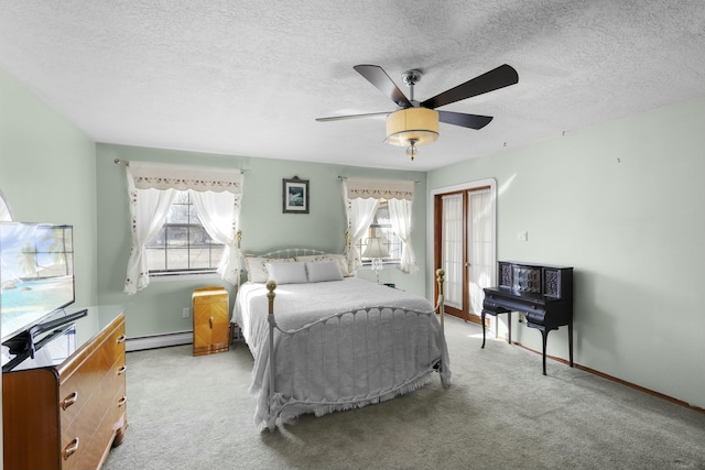 carpeted bedroom with ceiling fan, a baseboard heating unit, a textured ceiling, and a closet