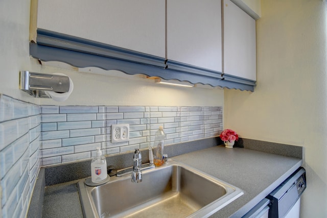 kitchen featuring white cabinetry, decorative backsplash, dishwasher, and sink