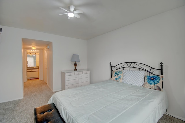 bedroom with carpet, connected bathroom, and ceiling fan