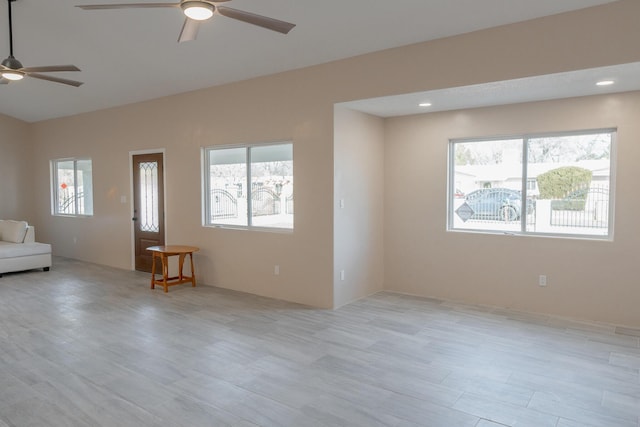 unfurnished living room featuring light wood-type flooring and ceiling fan