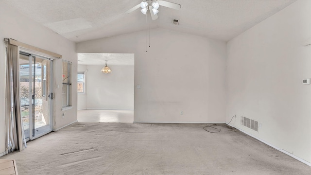 unfurnished room featuring ceiling fan, light colored carpet, a textured ceiling, and lofted ceiling