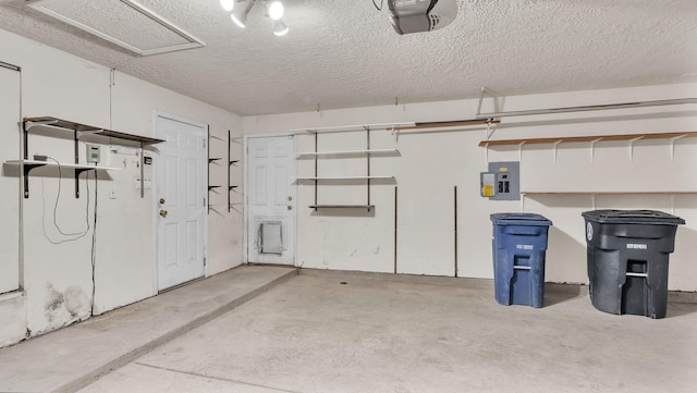 garage with electric panel and a garage door opener