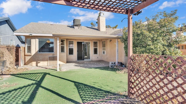 back of house with a pergola, a lawn, and a patio