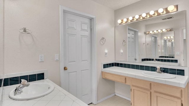 bathroom featuring a textured ceiling, vanity, and tasteful backsplash