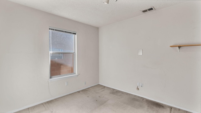 unfurnished room featuring a textured ceiling