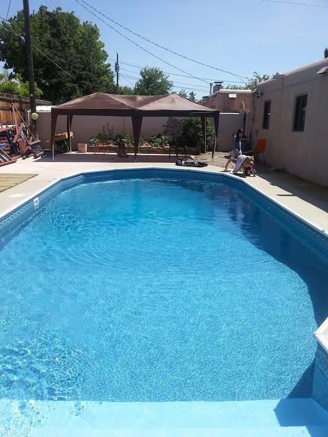 view of pool featuring a gazebo and a patio