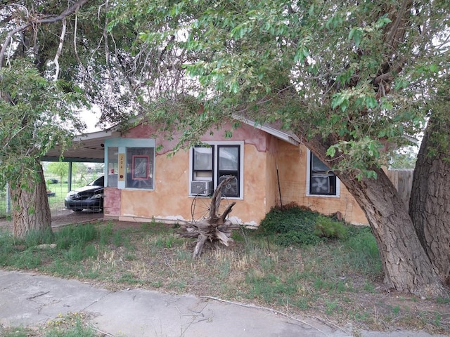 view of side of property with a carport