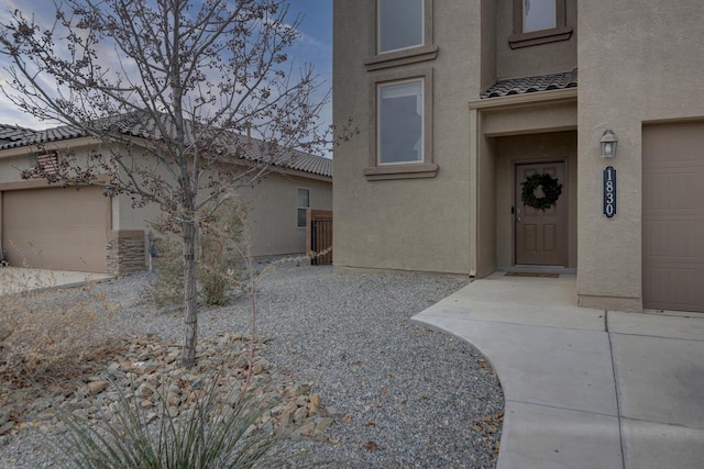 view of exterior entry featuring a garage