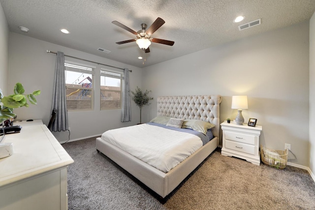 carpeted bedroom featuring a textured ceiling and ceiling fan