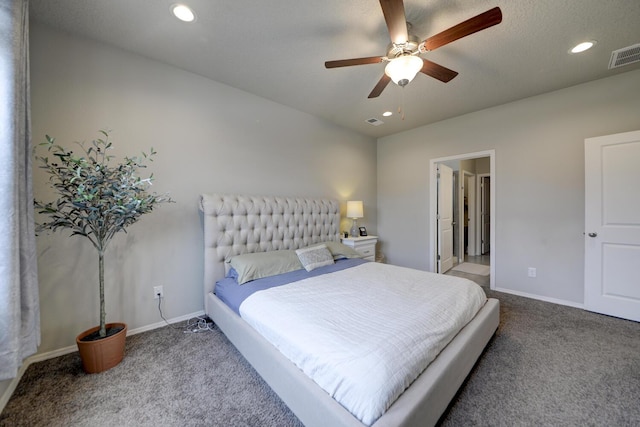 bedroom featuring ensuite bath, ceiling fan, carpet, and a textured ceiling